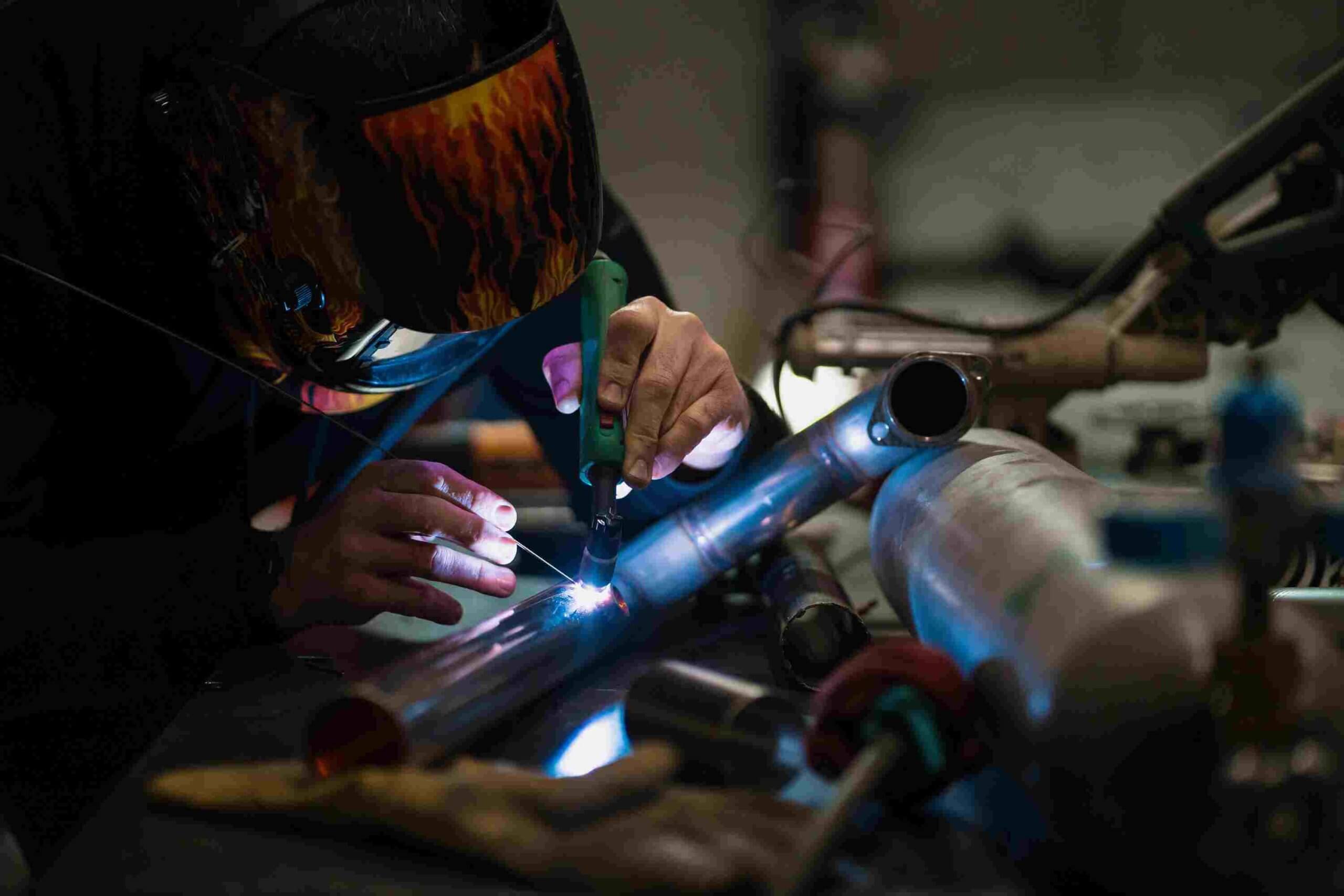 man-working-with-argon-welding-machine-garage